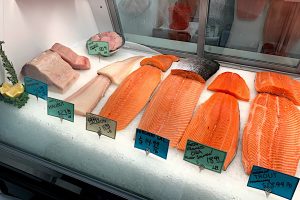 Display case of fresh swordfish, halbiut, salmon, and trout