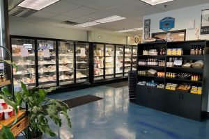 Interior photo of Sierra Gold Seafood market. there are shelves of various products. There are also freezers with a variety of products.